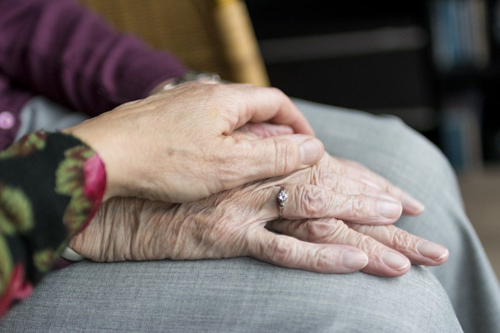 old and young hands clasped.