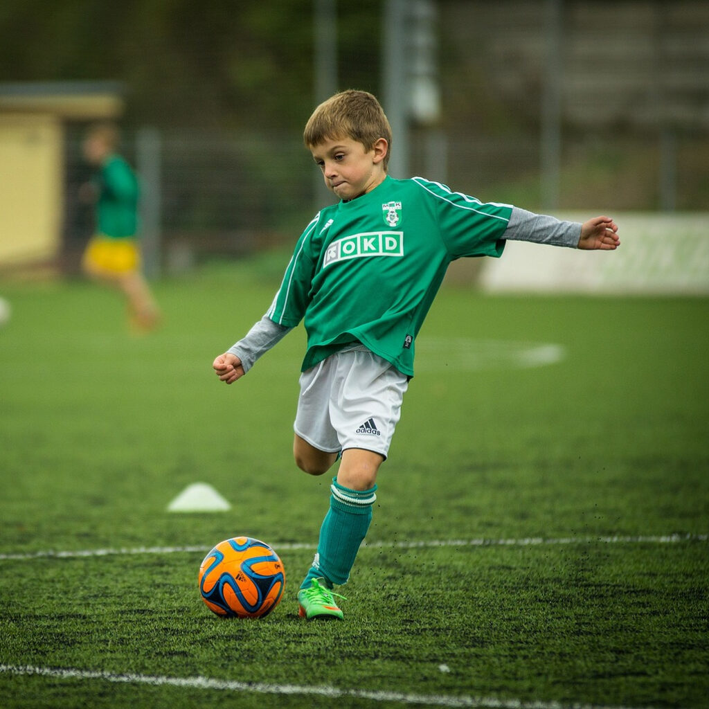 Child playing football.