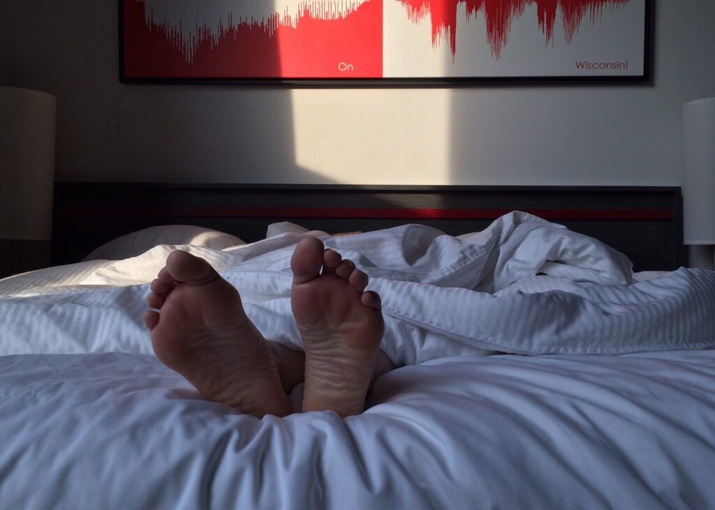 Feet sticking out of blankets.