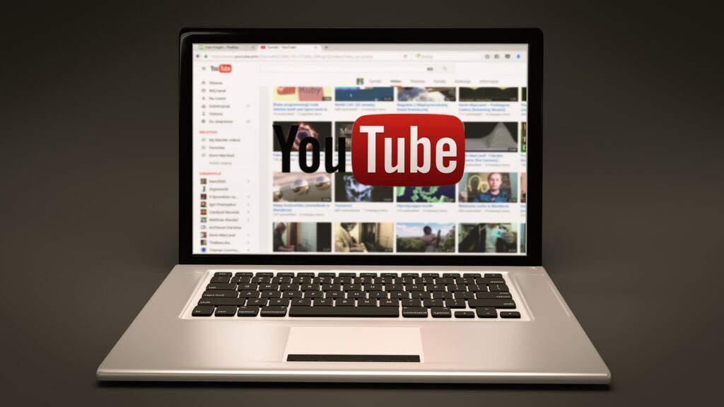 A laptop with YouTube in the background.