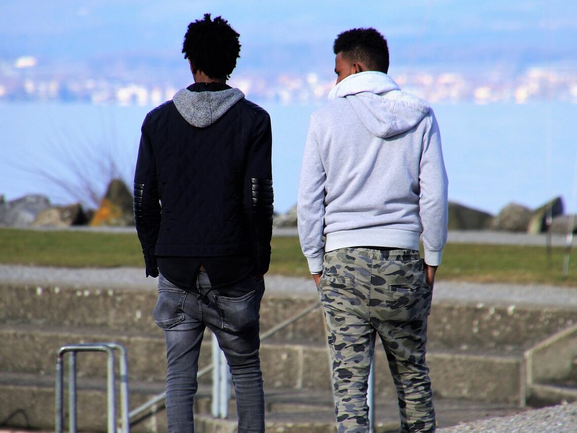 Two people standing looking into the distance.