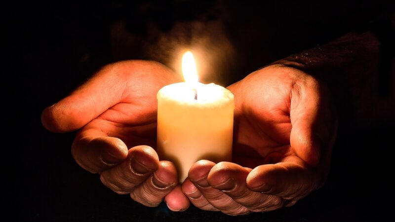 Candle in hands.