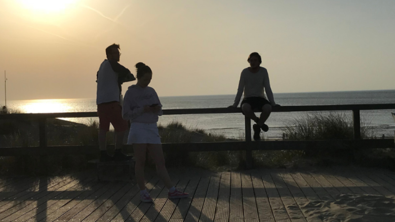 people at the beach at sunset