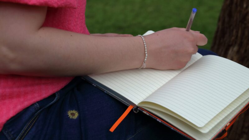 woman writing in a journal